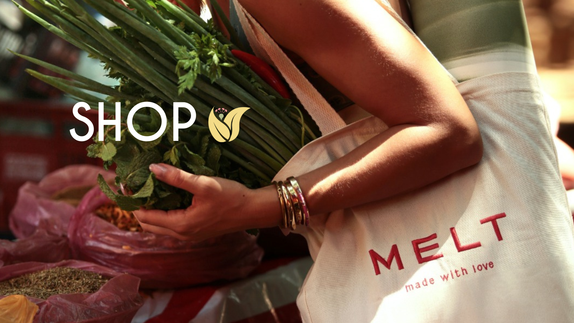 Person holding a bag of groceries with 'MELT' branding, surrounded by fresh produce.